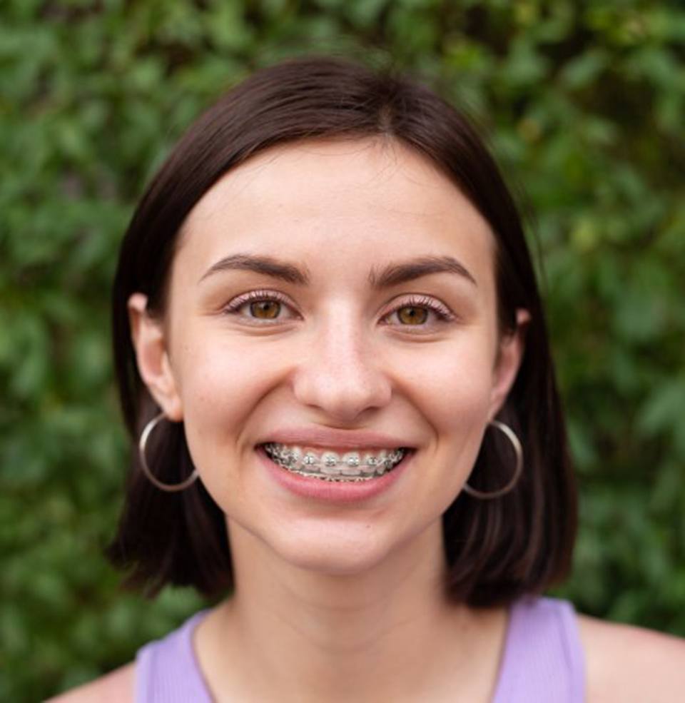 Smiling teenager after visiting her Cigna orthodontist in Lawrence