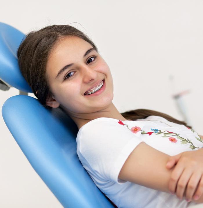 Young woman in dental chair smiling