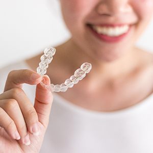 Person holding an Invisalign tray