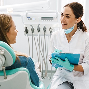 Lawrence orthodontist talking to patient about cost of Invisalign