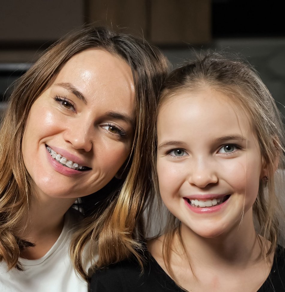 Mother and child smiling after visiting a MetLife orthodontist in Lawrence