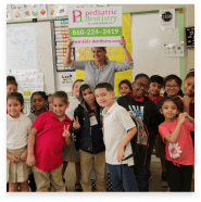 Orthodontic team member volunteering at a school