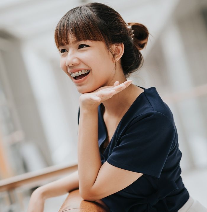 Smiling woman with self-ligating braces