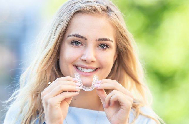 Woman placing an Invisalign tray