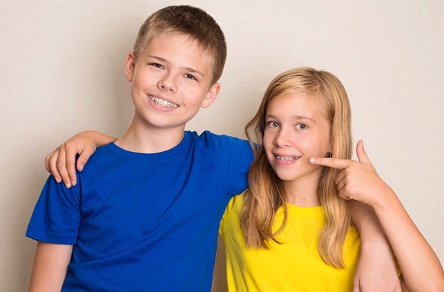 Young boy and girl with orthodontic appliances