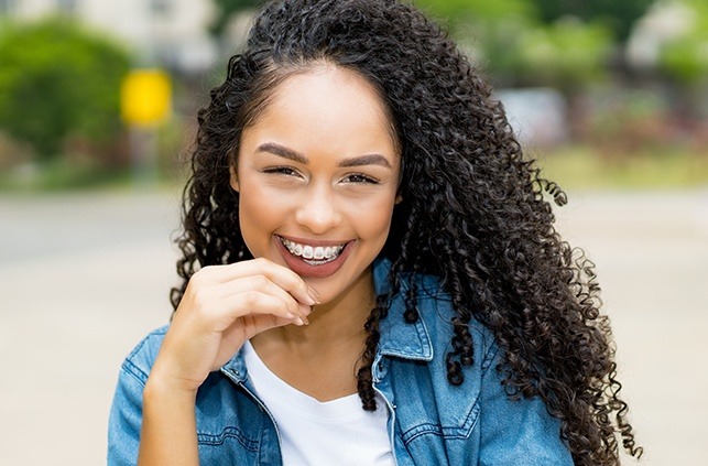 Young woman with self-ligating braces smiling outdoors