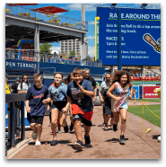 Group of children running the bases at sports event