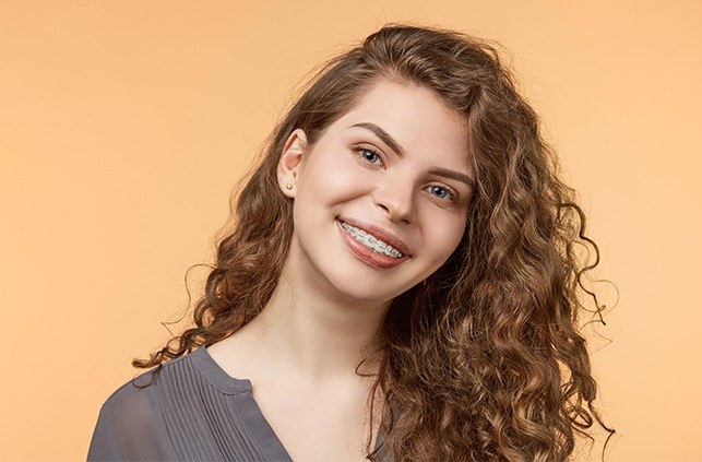 Woman with traditional braces smiling