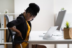 Woman correcting her posture to improve bite alignment 