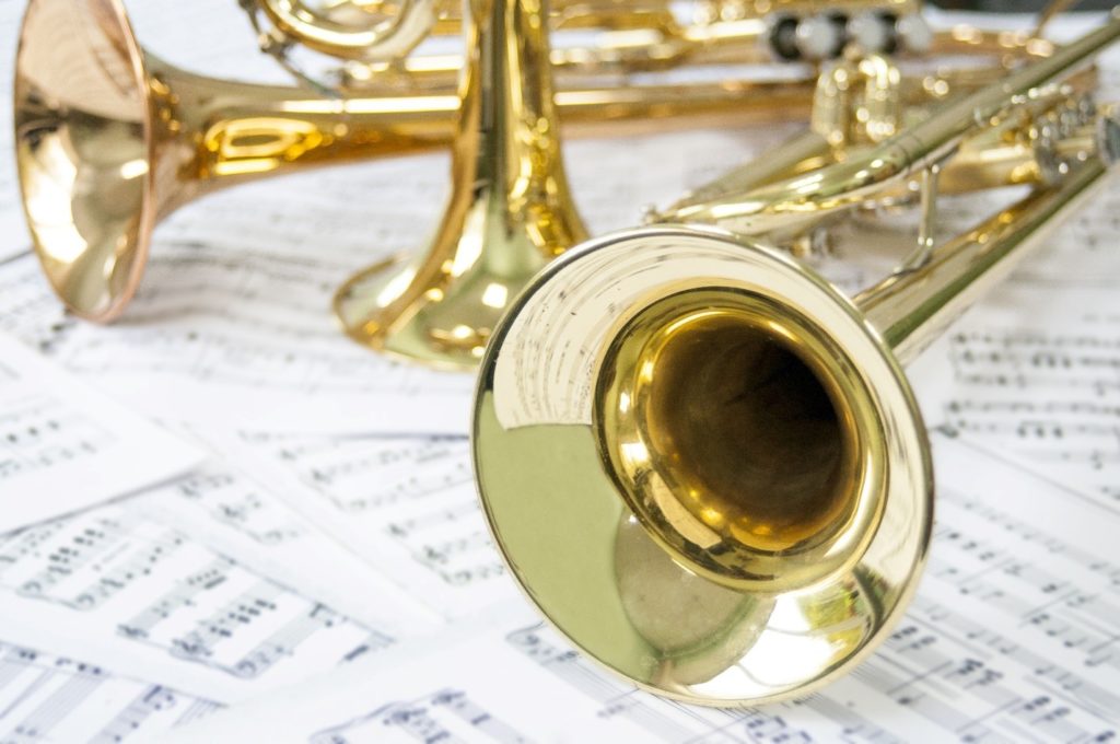 Golden trumpets lying on sheet music