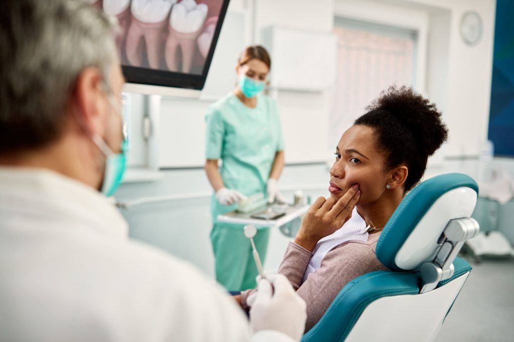 Woman talking to orthodontist about orthodontic emergencies