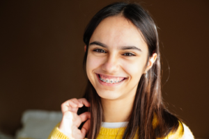 a patient pointing toward their braces